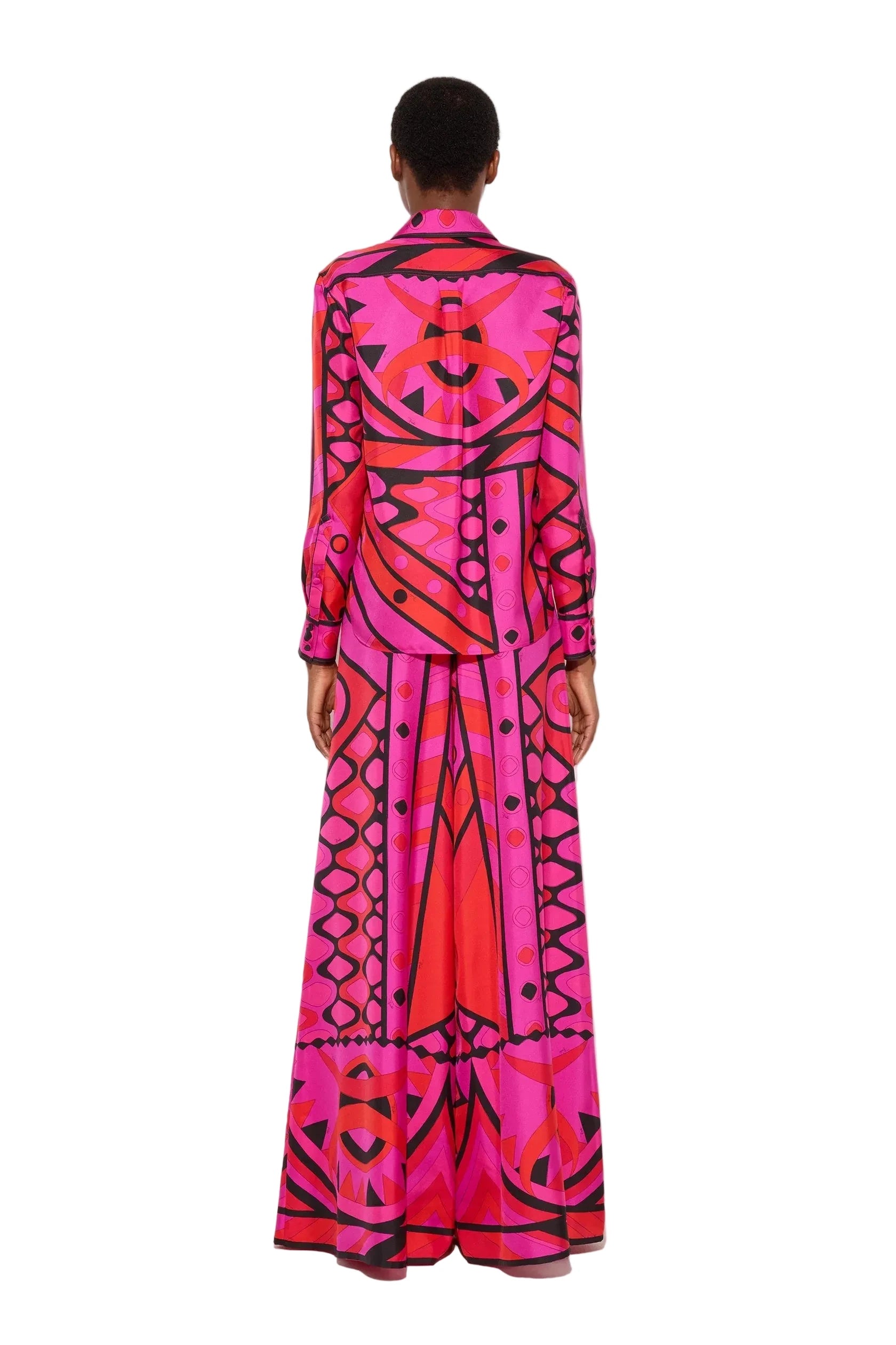 Person wearing a vibrant, patterned outfit on a white background