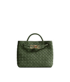 An olive green woven leather handbag with a top handle and a decorative gold-tone knot detail on the front, set against a clean light gray background.
