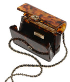 Tortoiseshell handbag with chain strap on a white background
