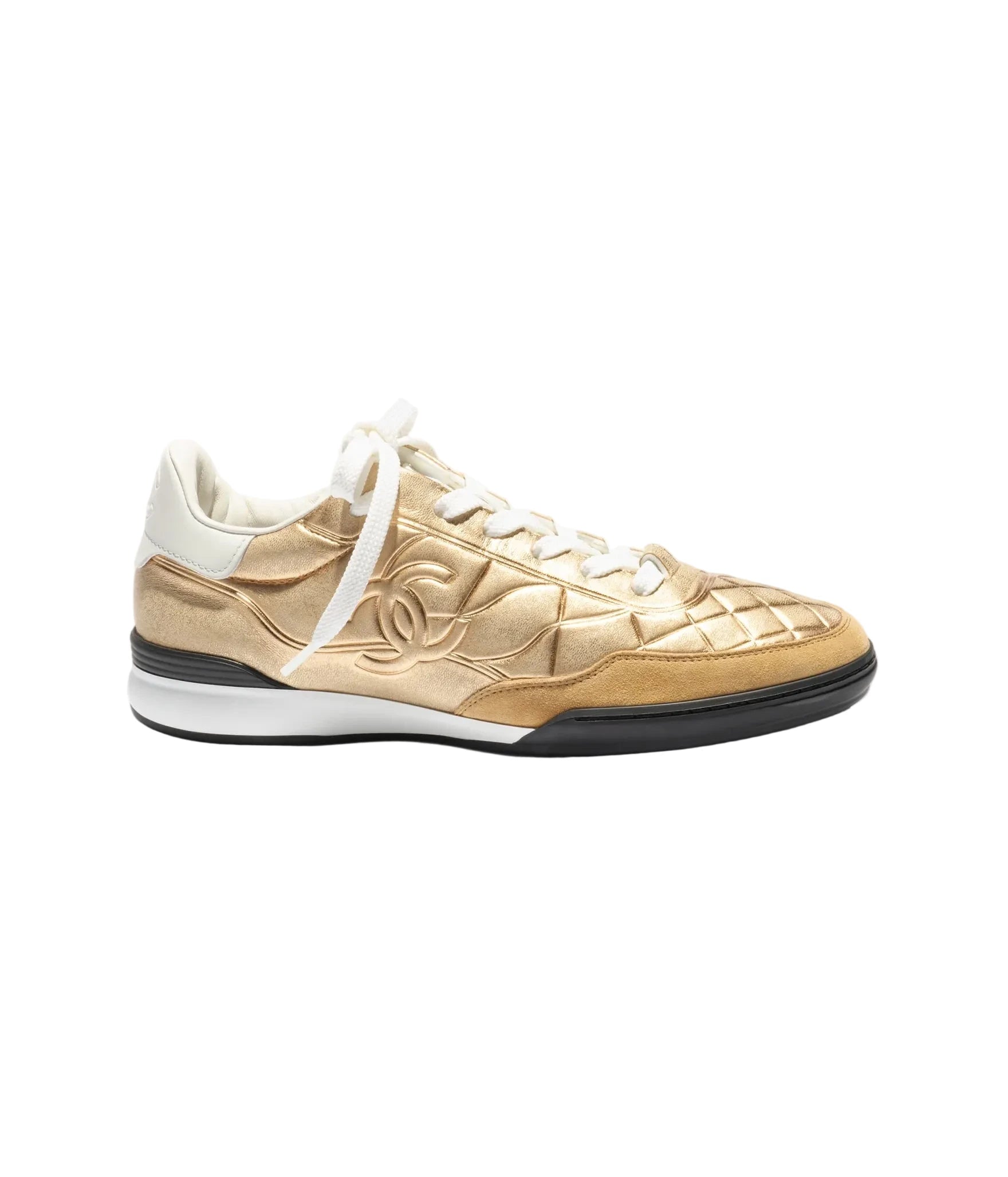 Gold sneaker with white laces on a light gray background