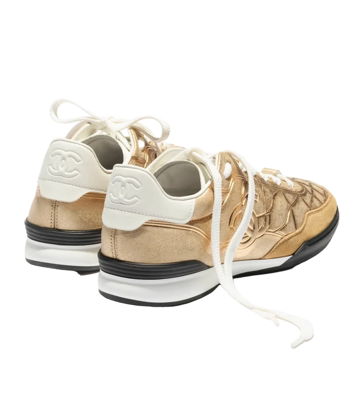 Beige and white sneakers with a brand logo on a white background