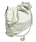 White quilted Chanel bag with chain details on a white background