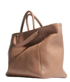 Quilted brown handbag on a light gray background