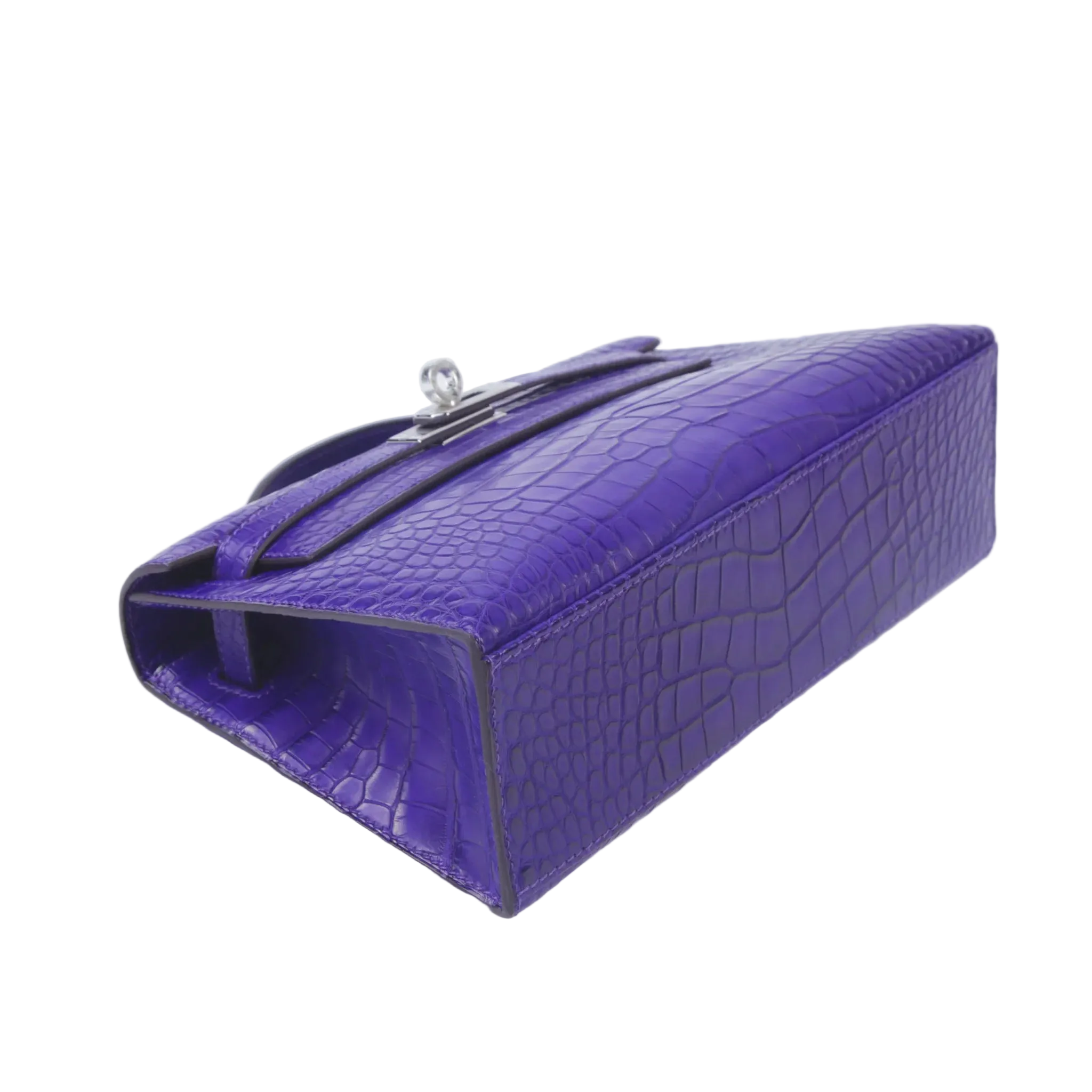 Purple crocodile-patterned handbag on a white background