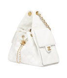 White handbag with gold chain and hardware on a white background