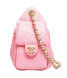 Pink quilted handbag with gold chain strap on a white background