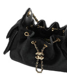 Black handbag with gold chain and CC logo on a white background