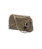 Quilted handbag with decorative charm on a white background