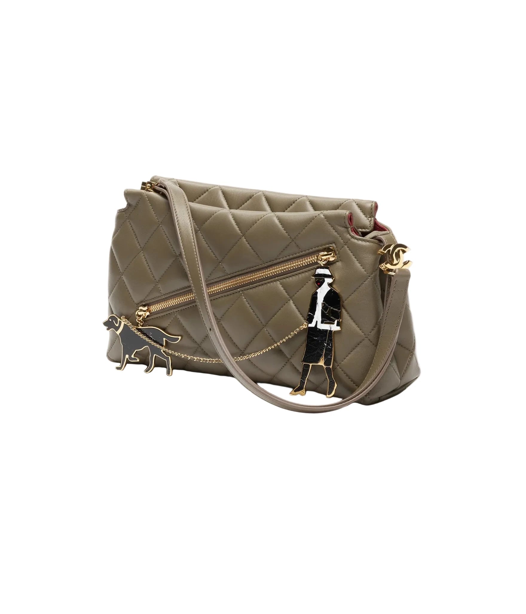 Quilted handbag with decorative charm on a white background
