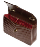A brown quilted leather handbag with a deep red interior lining and gold-tone hardware, shown open against a plain white background.