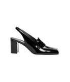 A single black patent leather slingback mule with a block heel and a small gold-tone monogram detail on the strap, shown in profile against a plain white background.