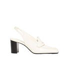 A single off-white leather slingback mule shoe with a chunky black block heel and a small gold-tone logo detail on the strap, shown against a plain white background.
