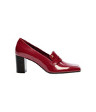 A single glossy red patent leather pump with a block heel and a small gold logo detail on the strap, shown in profile against a plain white background.