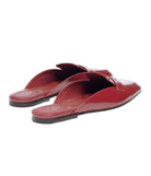 A pair of glossy burgundy patent leather mule loafers with a pointed toe and decorative strap detailing, shown on a clean white background.