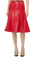 A bright red faux-leather A-line skirt with a matching red belt, shown on a model wearing beige and black pointed-toe heels against a plain white studio background.