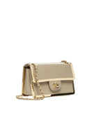 A structured flap shoulder bag in light beige leather with gold-tone hardware, a gold chain strap, and a prominent interlocking CC logo on the front, photographed on a clean white background.