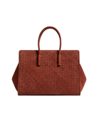 A structured brown woven leather handbag with dual top handles, photographed against a clean light gray studio background.