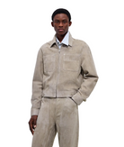 Man wearing a beige jacket and pants on a white background