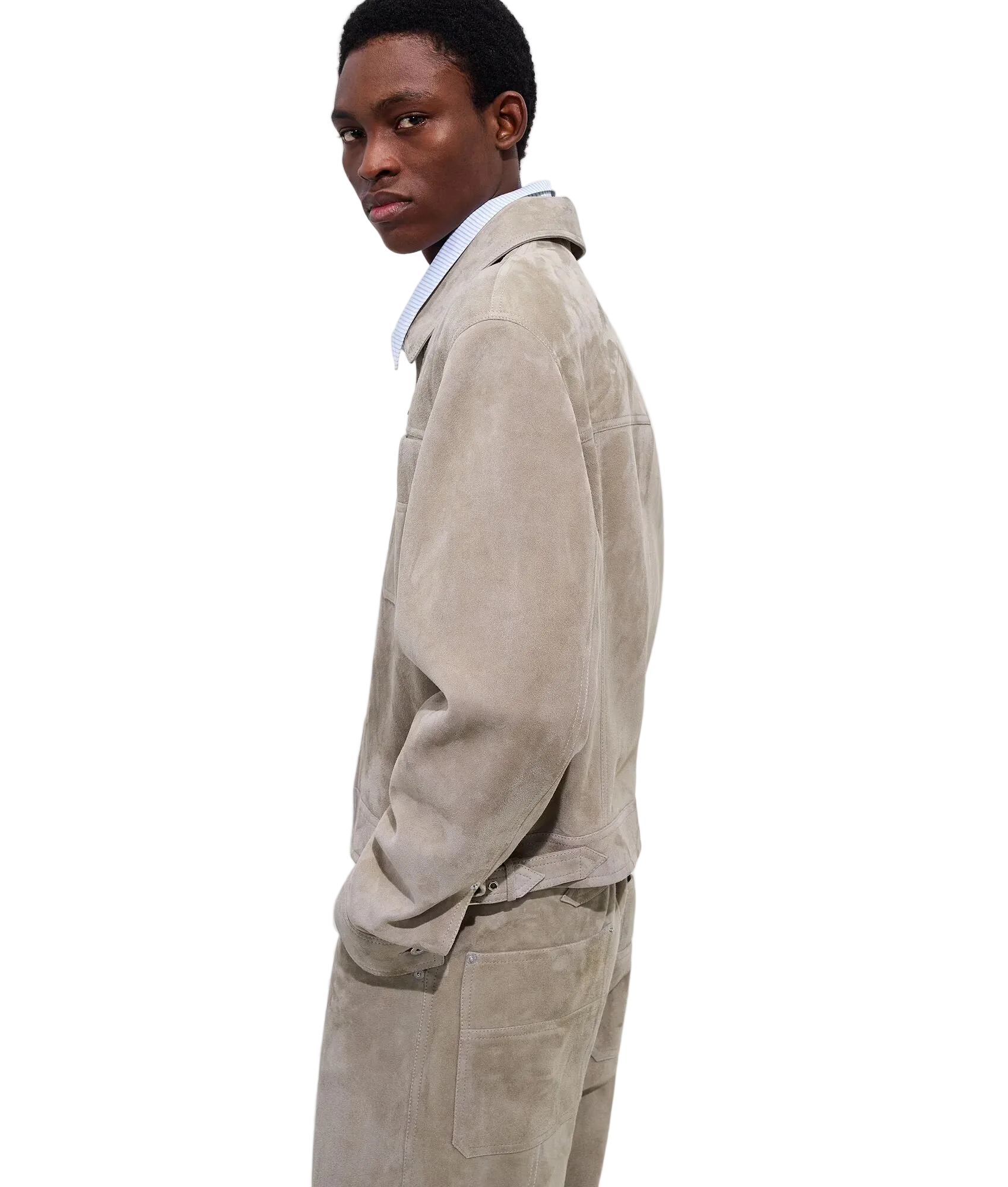 Person wearing a beige corduroy suit against a white background