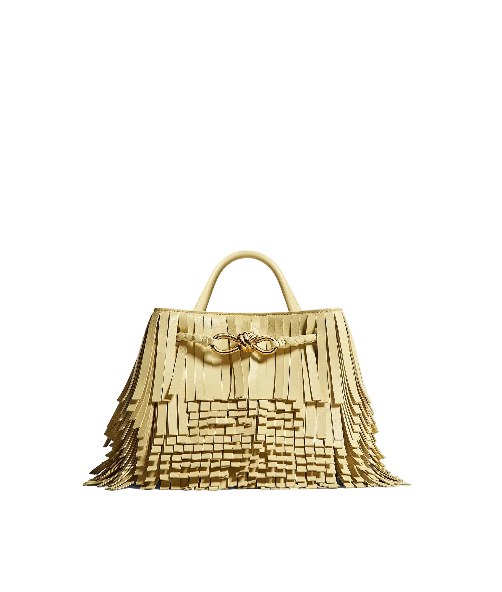 A light beige fringed leather handbag with a double top handle and a decorative bow detail on the front, set against a plain light gray background.
