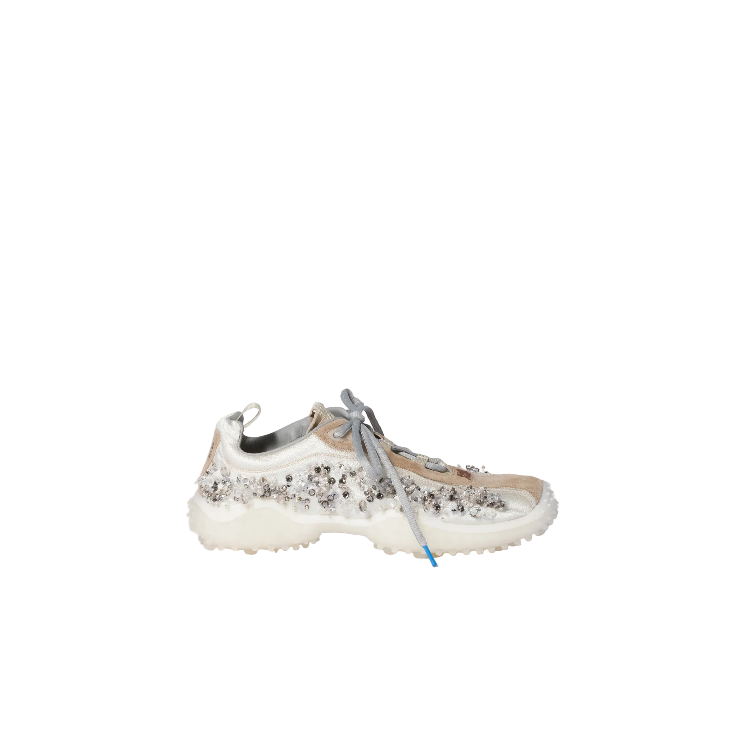 A single chunky sneaker with a white sole, beige mesh upper, and dense silver rhinestone embellishments, shown from the side against a solid light beige background.