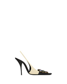 Black high-heeled shoe with a unique design on a white background