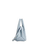 A light blue woven leather shoulder bag with a structured, slouchy shape and a single shoulder strap, shown from a side profile on a clean white background.