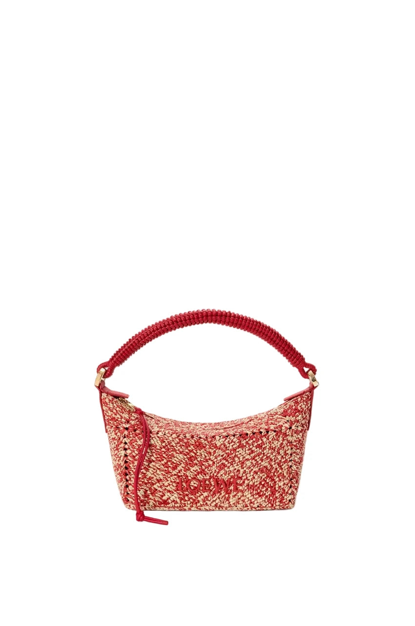 Red and beige handbag with a textured pattern on a light gray background