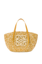 Yellow woven handbag with a brand logo on a white background