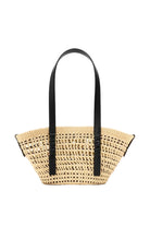 Woven handbag with black handles on a light gray background