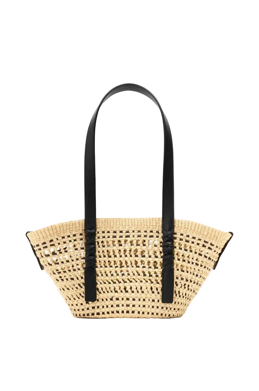 Woven handbag with black handles on a light gray background