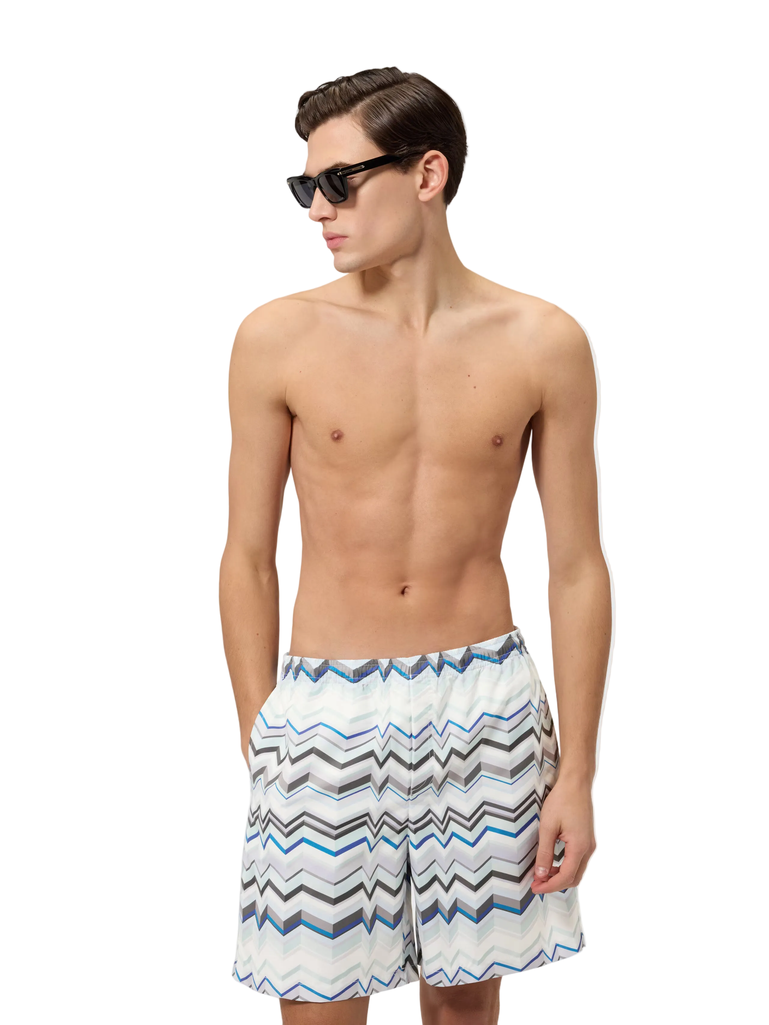 Man wearing striped swim shorts on a white background