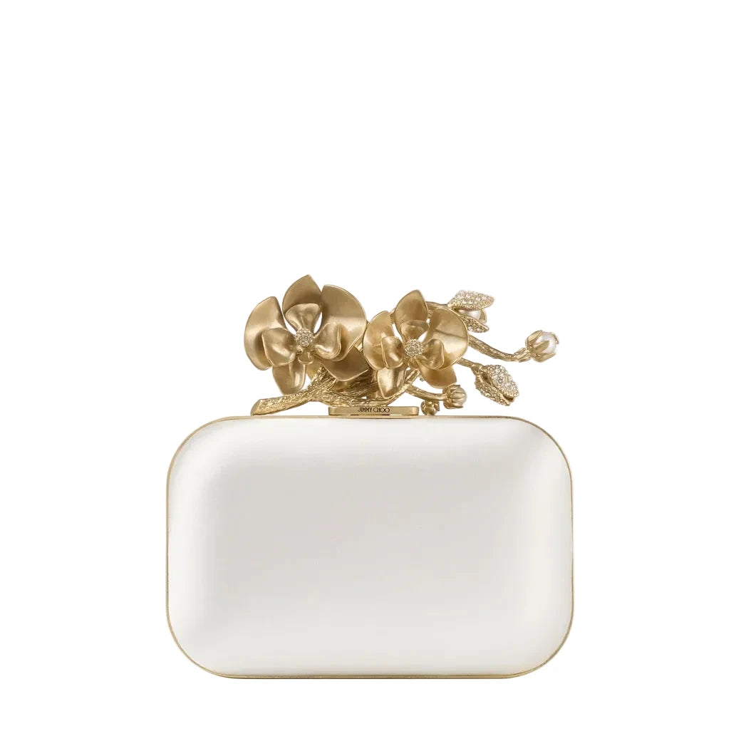 White clutch with gold floral design on a white background