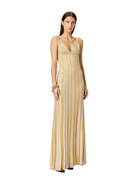 Woman wearing a long, light-colored dress with vertical stripes on a white background