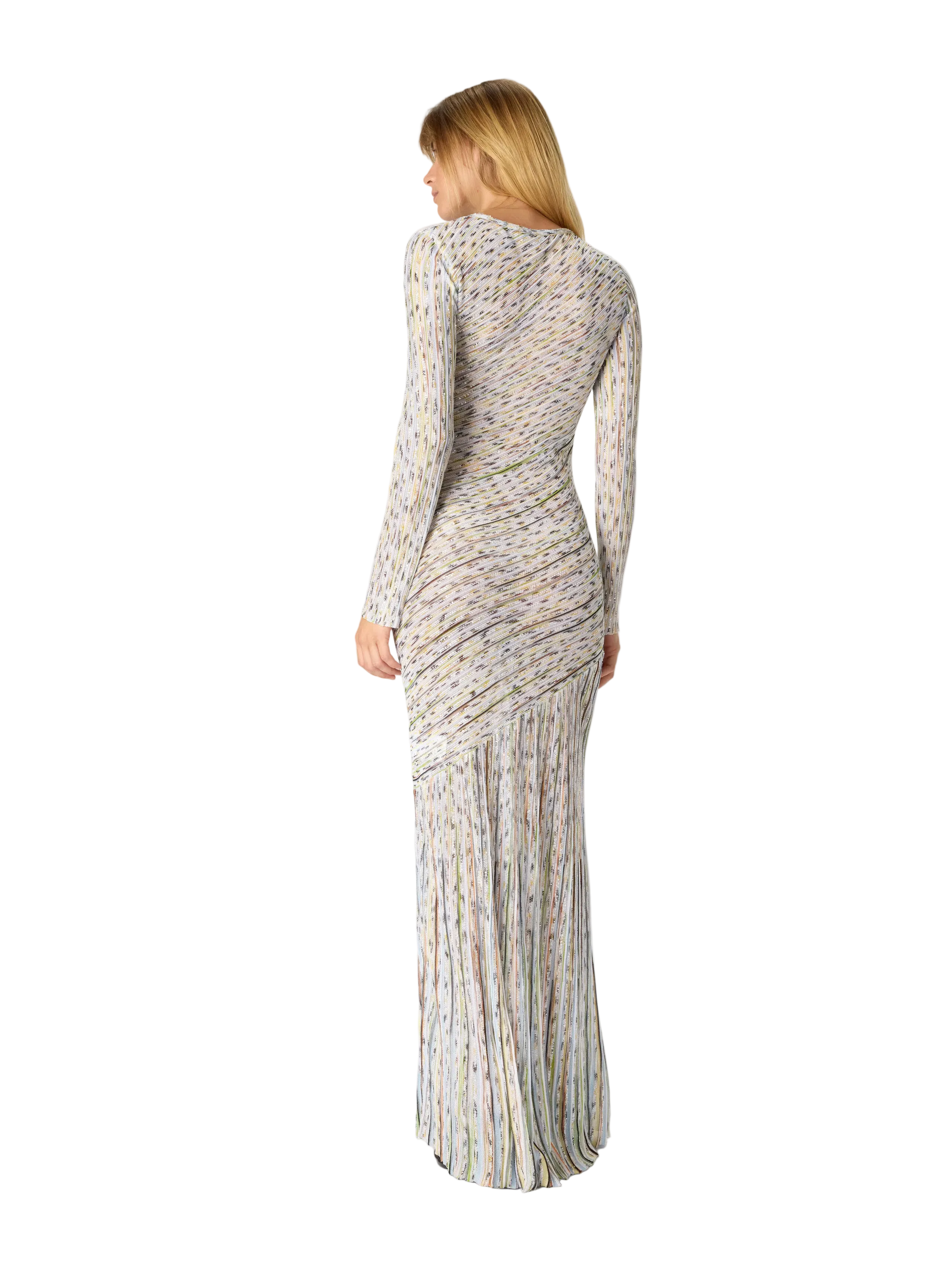 Woman wearing a long, patterned dress on a white background