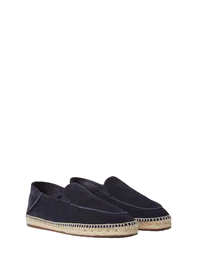 Pair of navy blue espadrilles on a light beige background
