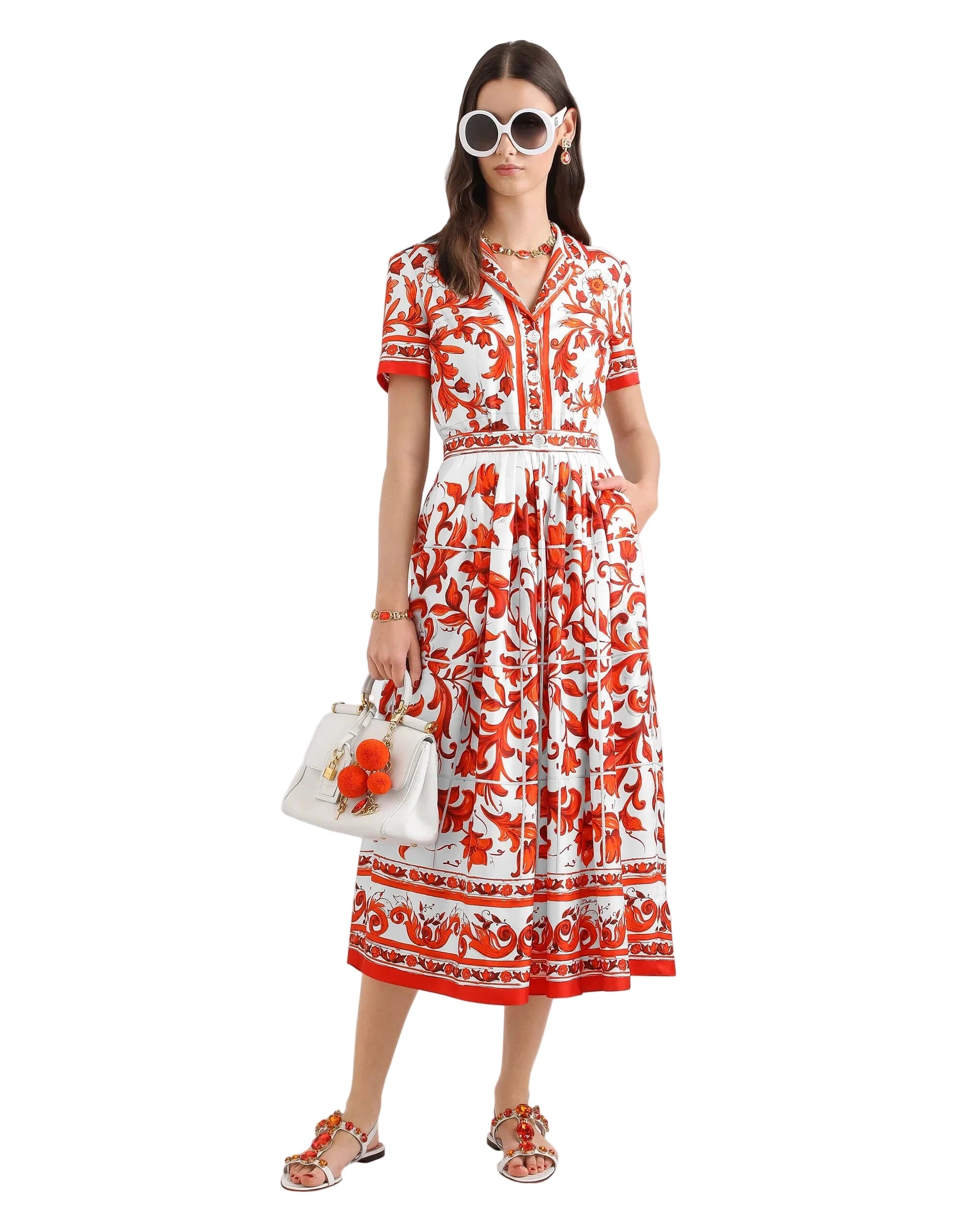Woman wearing a red and white floral dress on a white background
