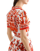 Red and white patterned dress on a plain background