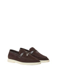 Pair of brown loafers on a light beige background