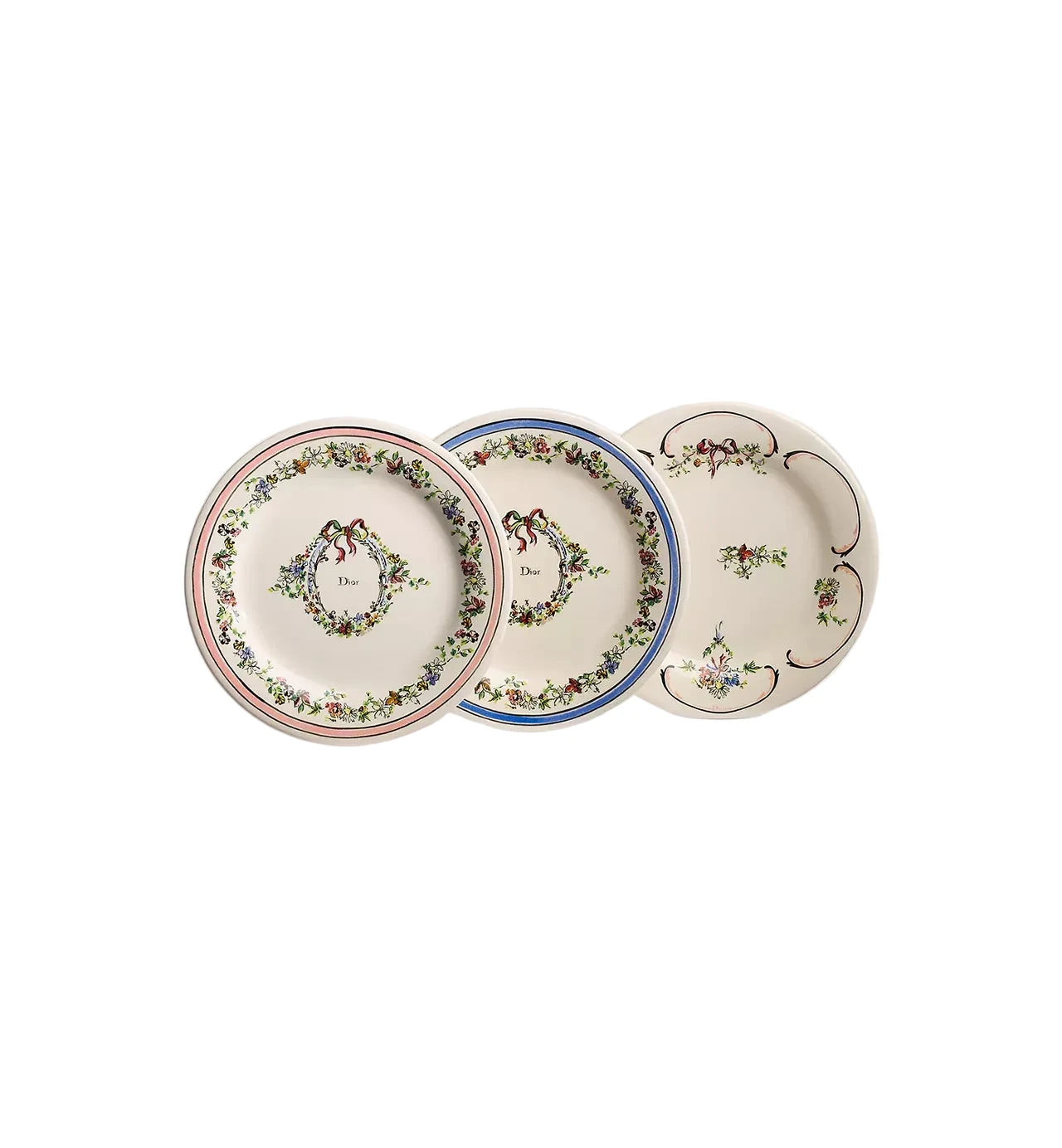 Three decorative ceramic plates with floral and monogram patterns, displayed overlapping on a clean white background.