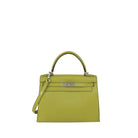 A structured lime green leather handbag with silver-tone hardware, featuring a top handle, a detachable shoulder strap, and a front flap closure, photographed against a plain light gray background.