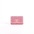 A small Chanel tweed wallet in pink and blue with a pink leather CC turn-lock closure, photographed on a clean white background.