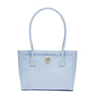 A light blue crocodile-embossed leather tote bag with double top handles and a gold-tone interlocking G logo on the front, set against a plain white background.