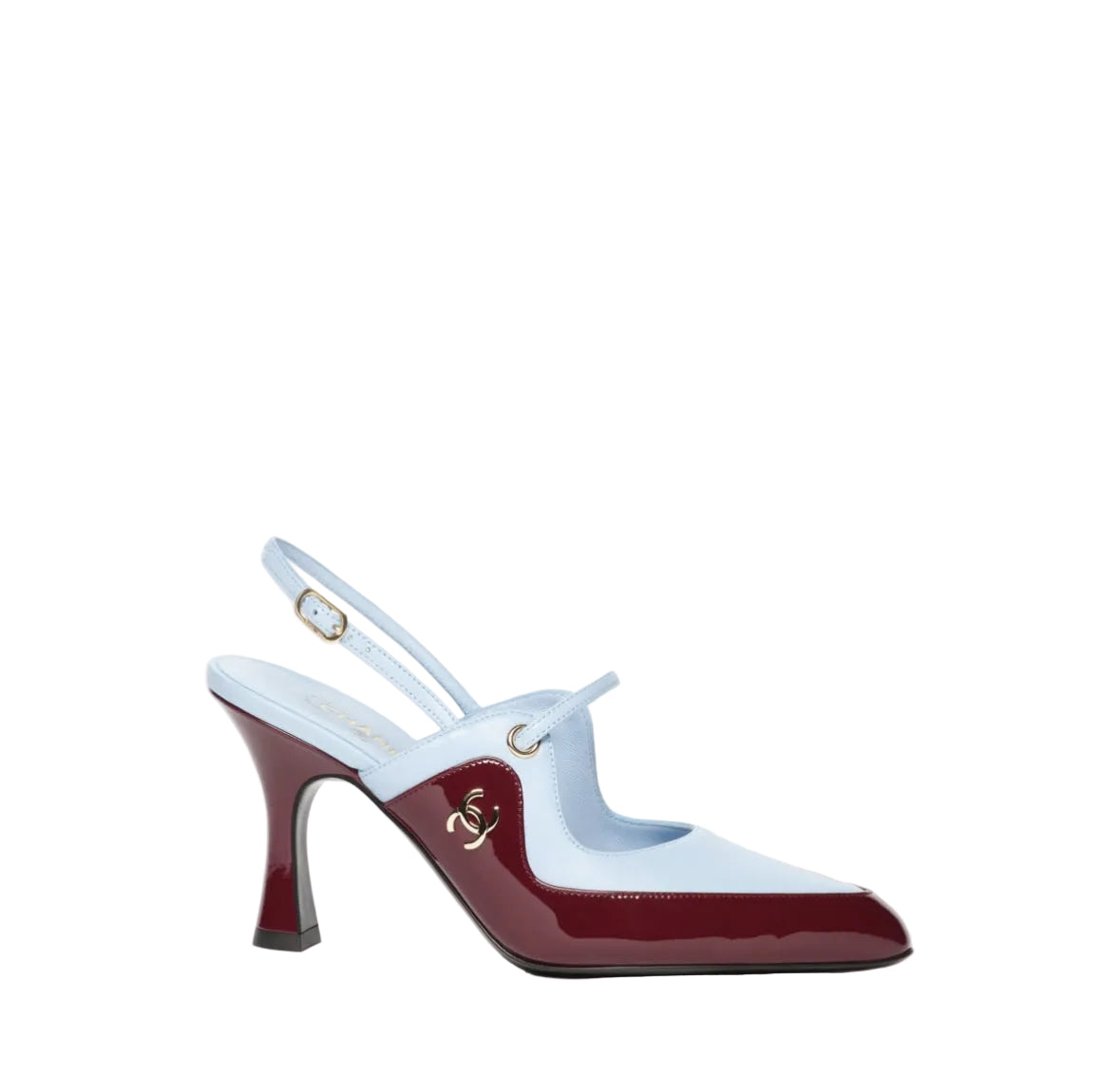 A single women's slingback high heel shoe with a light blue upper and a glossy deep burgundy patent leather toe cap and heel, featuring a small gold-tone anchor emblem on the side.