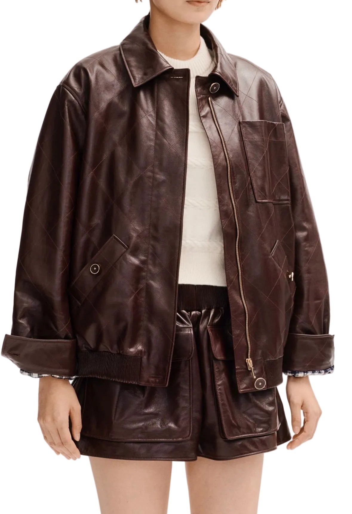 Person wearing a brown leather jacket and shorts on a white background