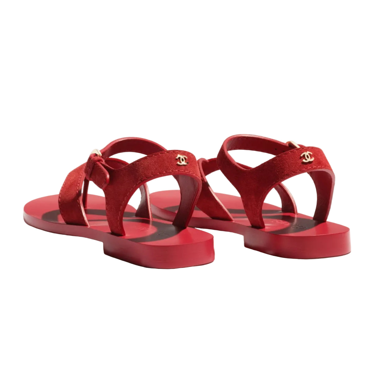 Red sandals with a visible brand logo on a white background