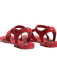 Red sandals with a visible brand logo on a white background