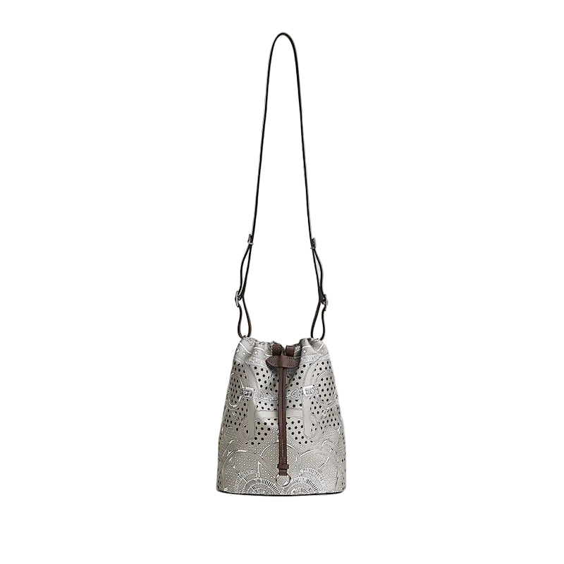 Silver drawstring bag with floral patterns on a light gray background