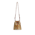 Patterned bucket bag with a strap on a light beige background