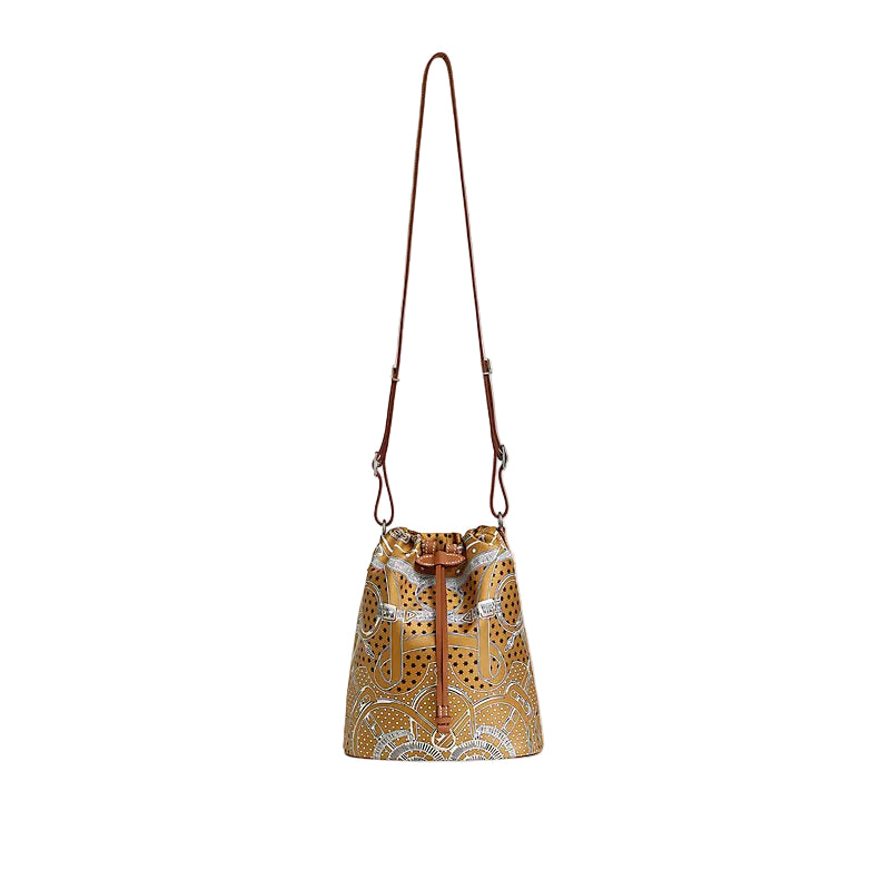 Patterned bucket bag with a strap on a light beige background